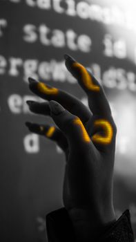 A striking black and white hand with glowing digital overlays capturing modern technology and art.