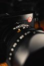Black Nikon Camera Lens on Brown Wooden Table