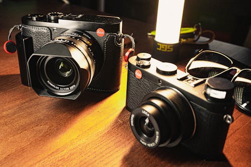 Free Leica Cameras on a Wooden Table Stock Photo