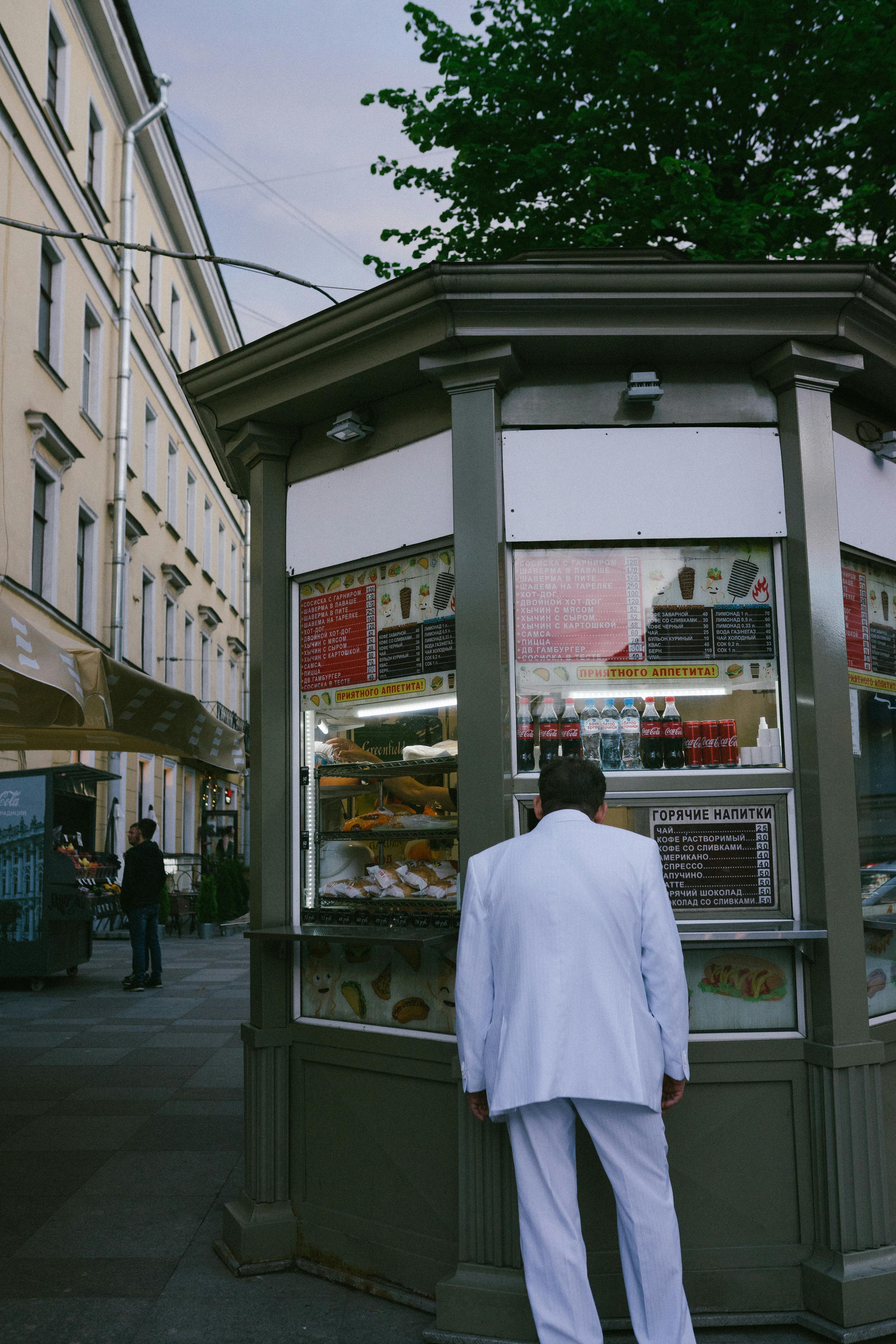 Man in White Coat Looking at the Store · Free Stock Photo