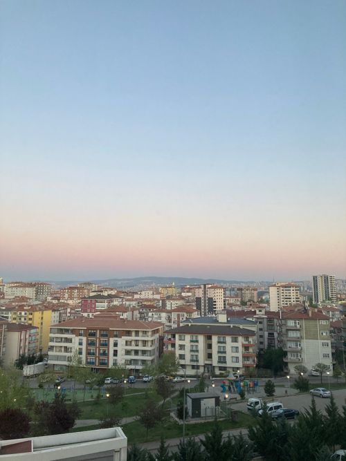 Free Aerial view of a cityscape under a pastel twilight sky with buildings. Stock Photo
