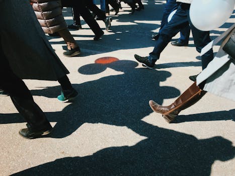 A vibrant street view showcasing people walking with distinct shadow play on Yakutsk pavement.