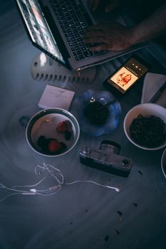 Top view of a creative workspace featuring a camera, laptop, and other essentials, ideal for stock media use.