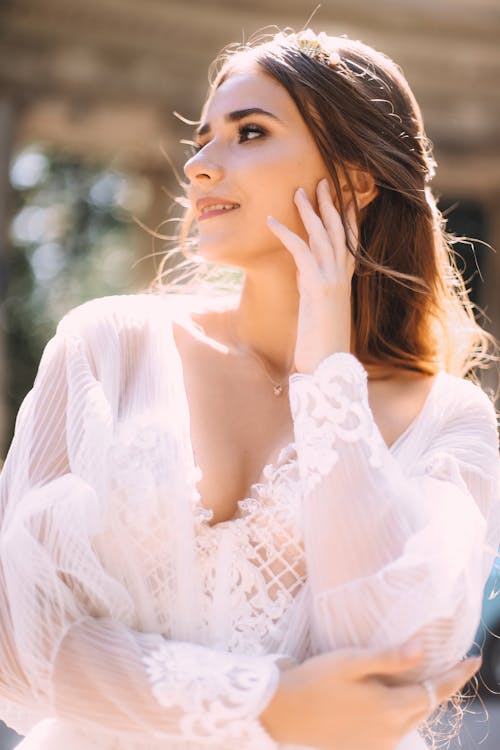Photo of a Woman in a White Lace Blouse in Sunshine