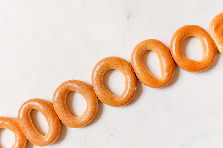 Brown Bagels On White Surface