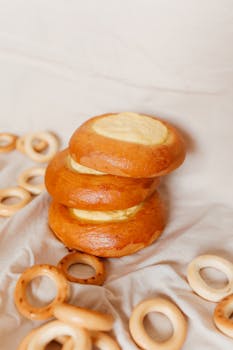 Stack of sweet Russian pastries and sushki on cloth, showcasing traditional treats.