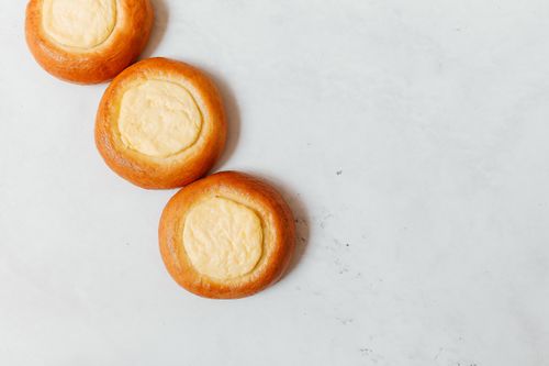 Free Three vatrushka pastries on a white surface, showcasing traditional Russian baking. Stock Photo