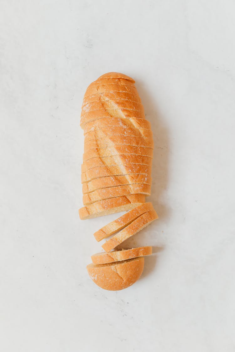 A Sliced Bread Loaf On A White Surface