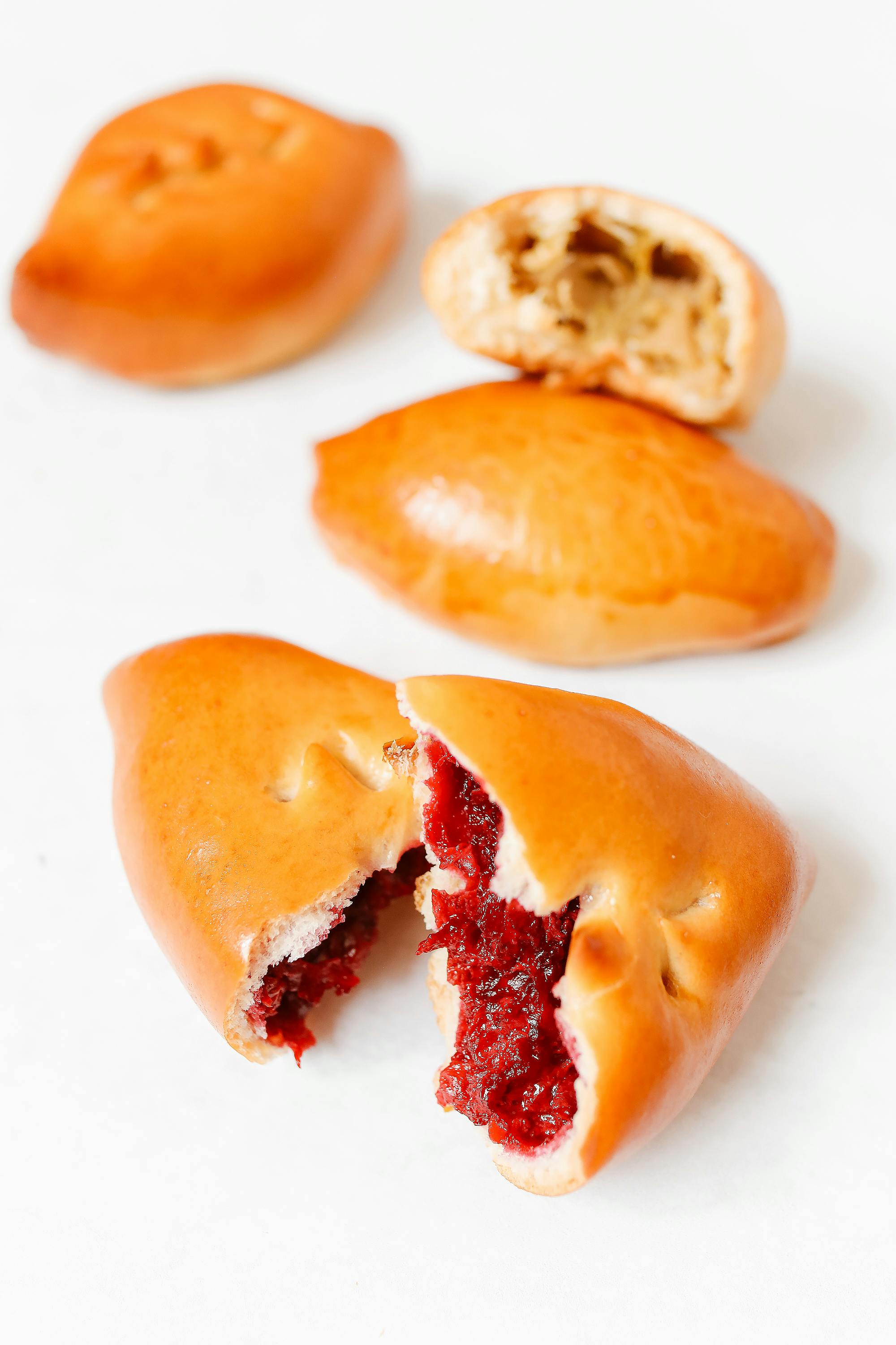 Close-up Photo of Pirozhki Bread on White Surface · Free Stock Photo