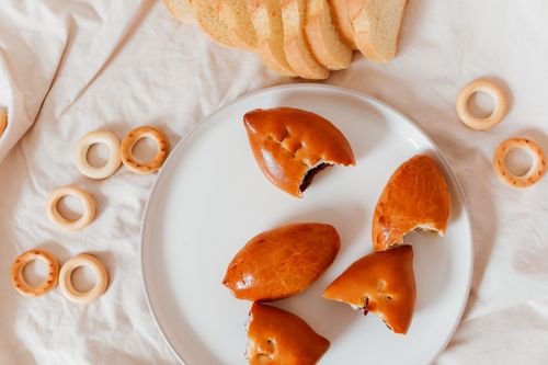 Free Top view of fresh baked pastries and sliced bread on a white plate, perfect for food photography. Stock Photo