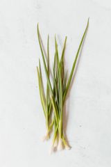 Fresh green onions on a pale surface — photo by Polina Tankilevitch on Pexels