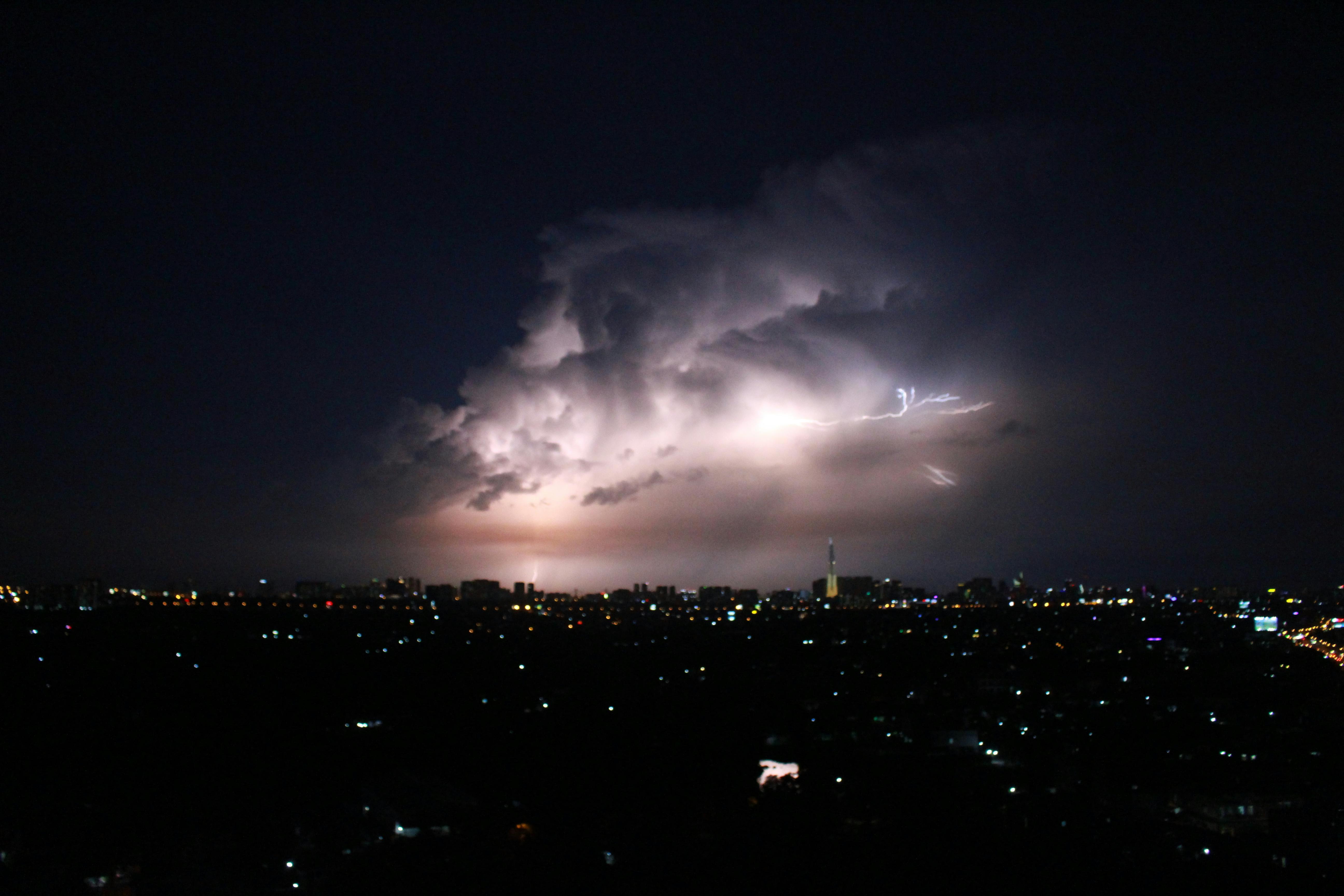 Premium AI Image  lightning strikes over a city at night with a church in  the background