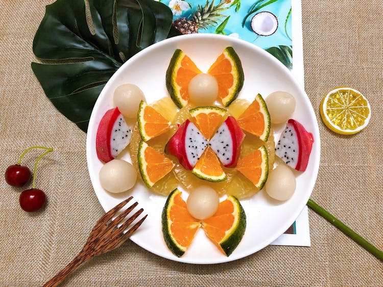 Orange And Dragon Fruit Slices On The Ceramic Plate