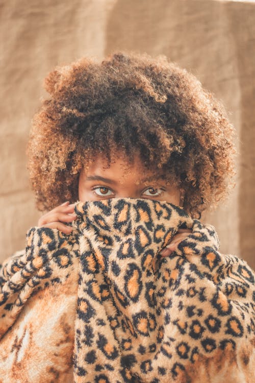 Free Woman Covering her Face with Leopard Cloth Stock Photo