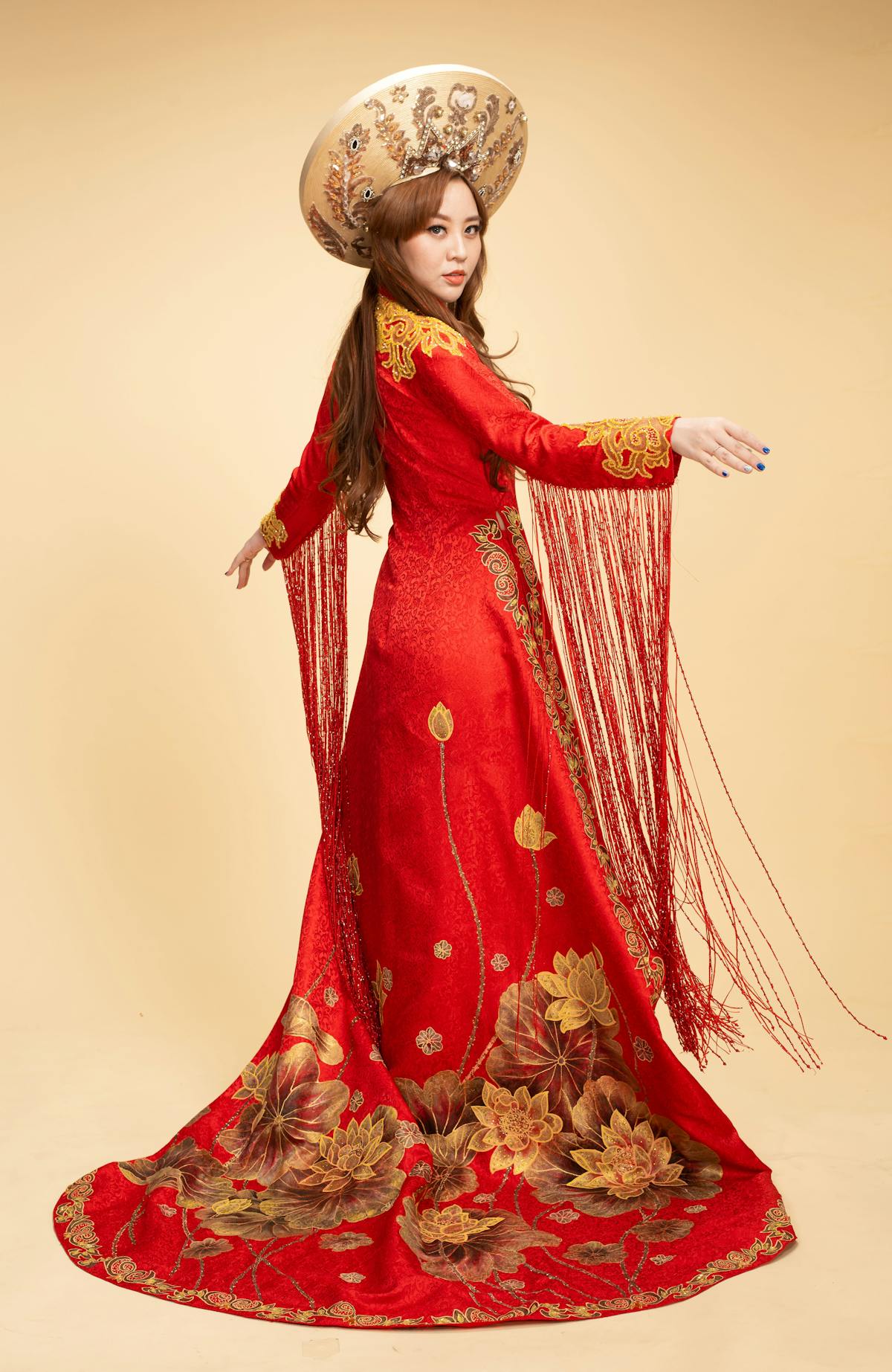 Hand arranging 3D patchwork petals and tassels for blouse