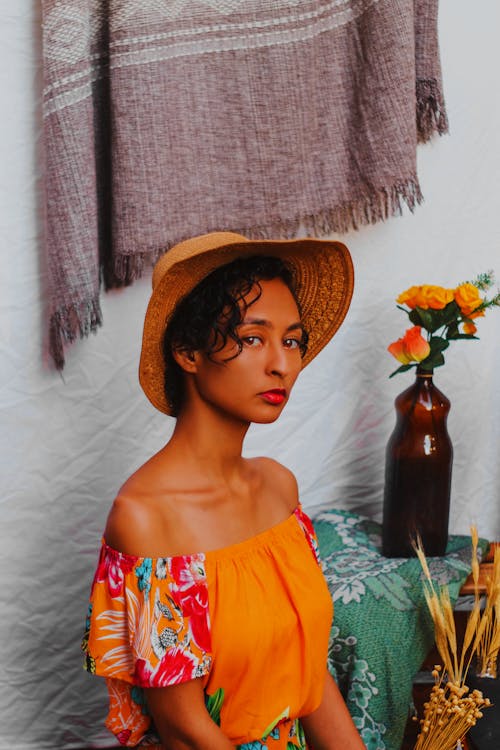 Woman in Orange Dress and Sun Hat