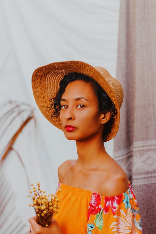 Woman in Orange Dress and Brown Sun Hat