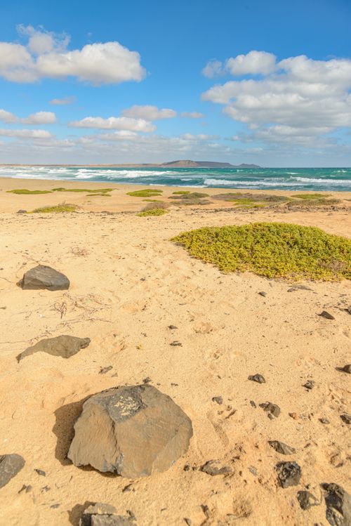 Free Serene beach landscape with blue ocean and sky, perfect nature escape. Stock Photo