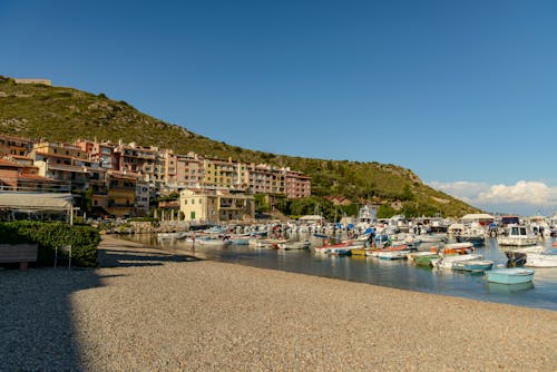 Houses by the Beach and Boats in the Sea
