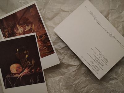 Printed postcard resting beside a blank card on textured paper — photo by Diana on Pexels
