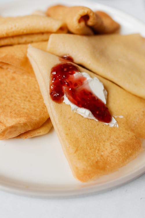 Close-Up Shot of Delicious Russian Pancakes on White Ceramic Plate