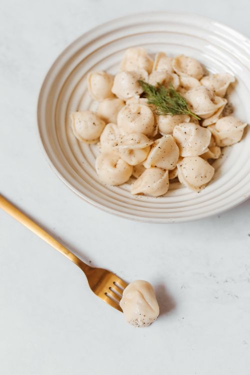 Free Tasty dumplings with herbs on a ceramic plate, perfect for food enthusiasts. Stock Photo