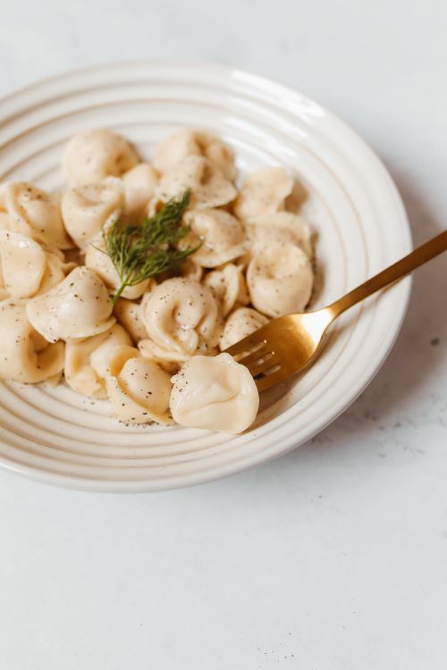 Free Close-up of Russian pelmeni topped with dill on a plate. Stock Photo