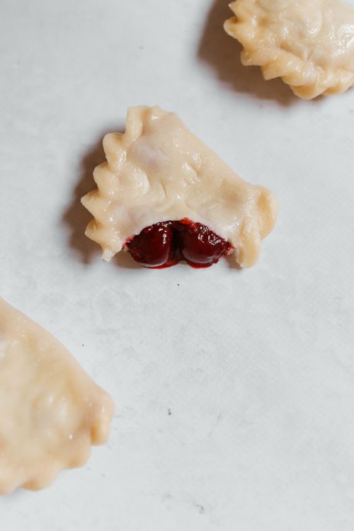 Free Delicious close-up of vareniki with cherry filling, showcasing traditional Russian dumplings. Stock Photo