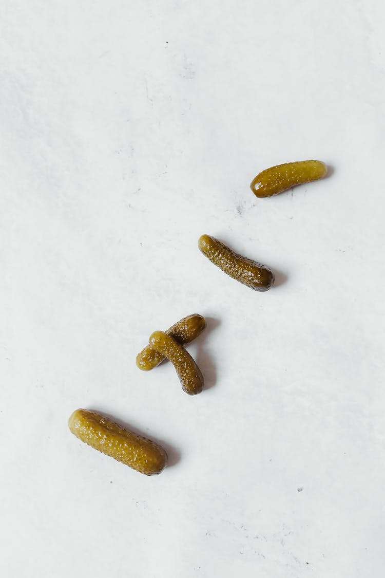 Pickled Cucumbers On A White Surface