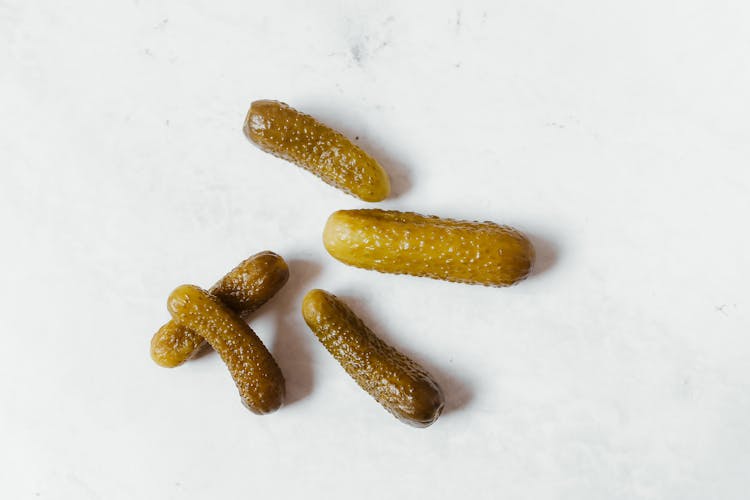 Cucumber Pickles On White Surface