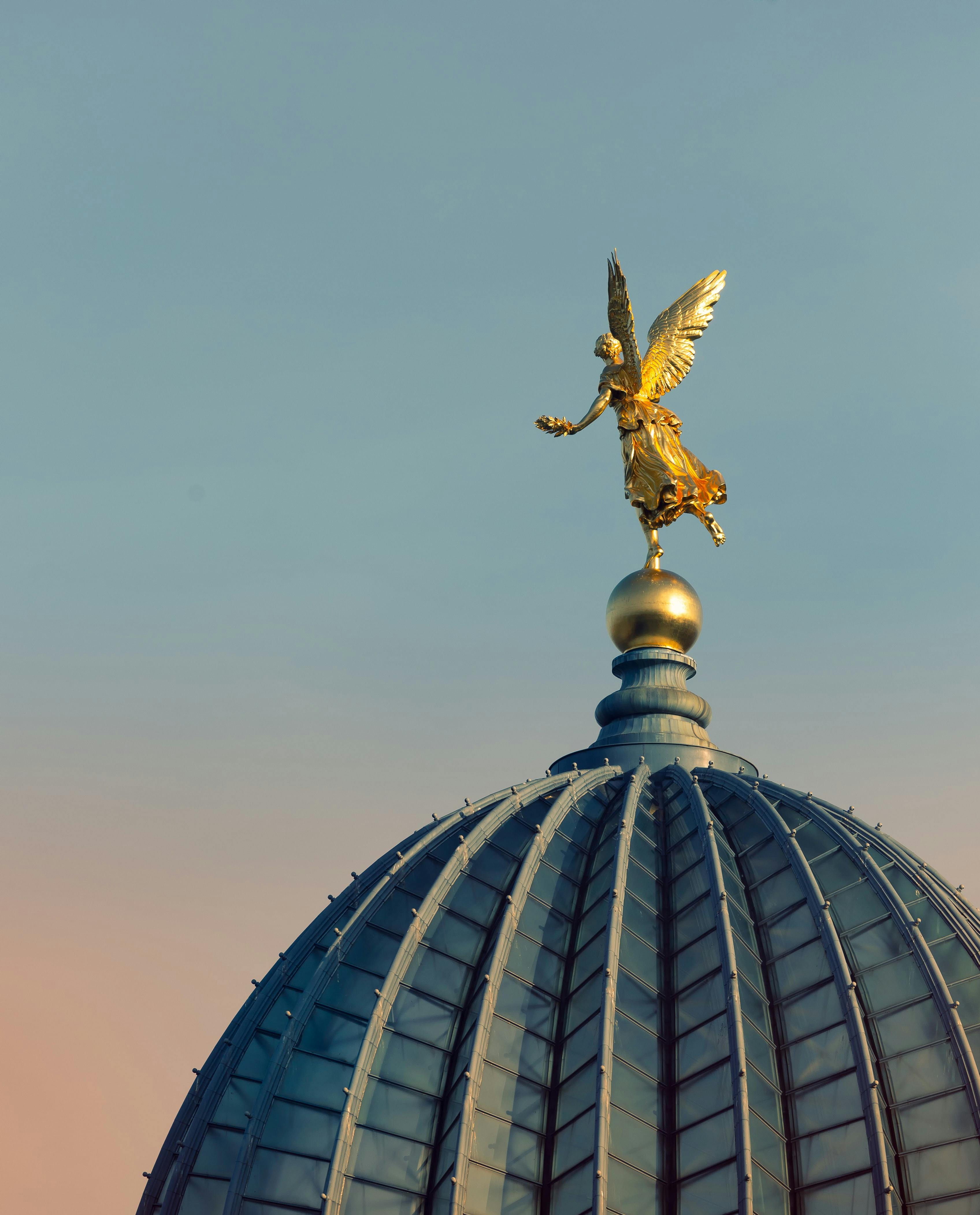 gold angel statue o top of a dome roofing