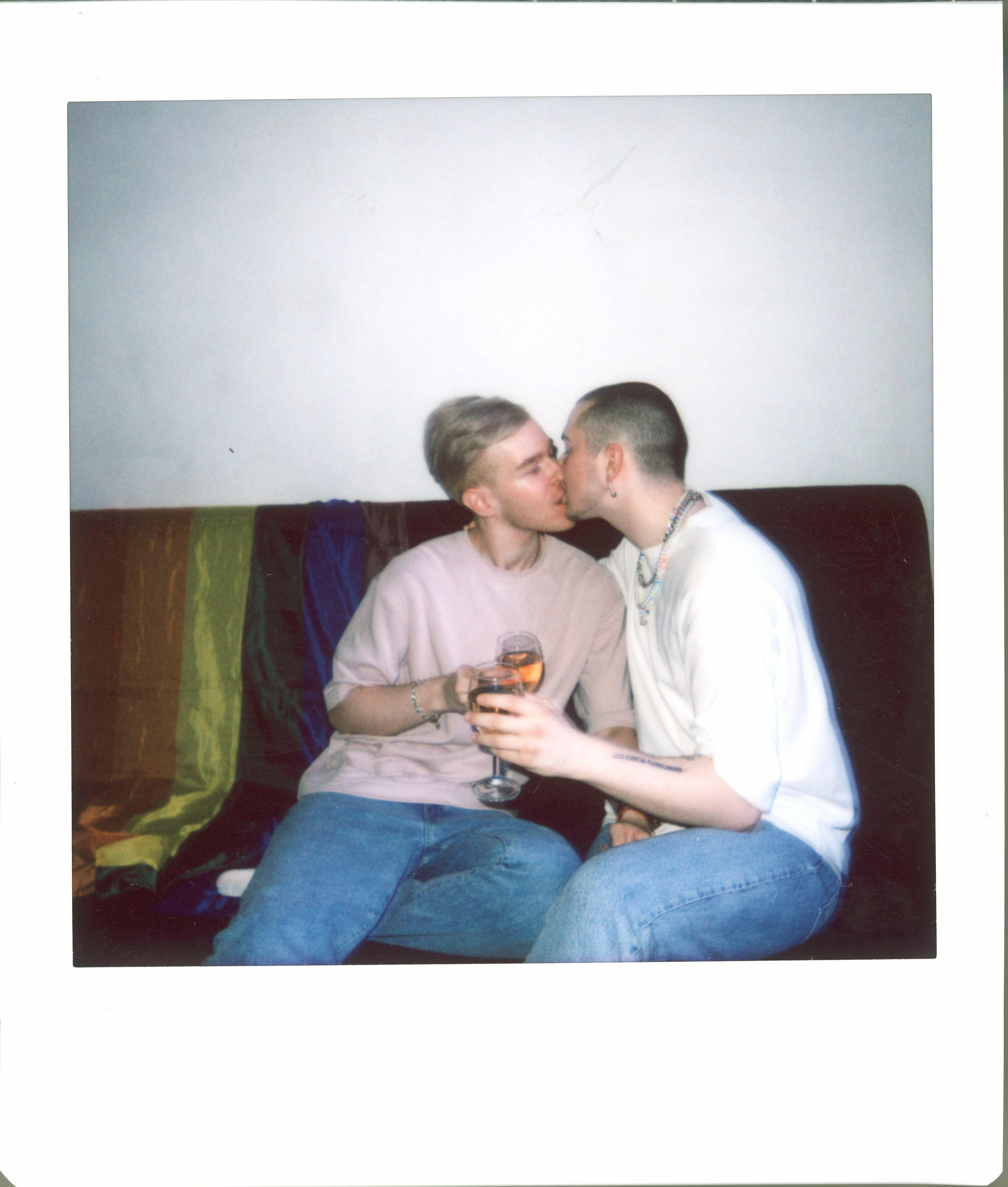 a couple kissing each other while sitting on the couch