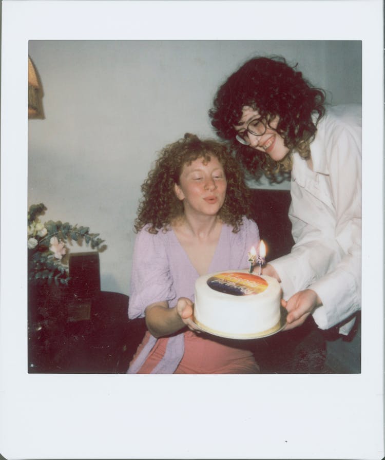 A Woman Blowing His Birthday Cake