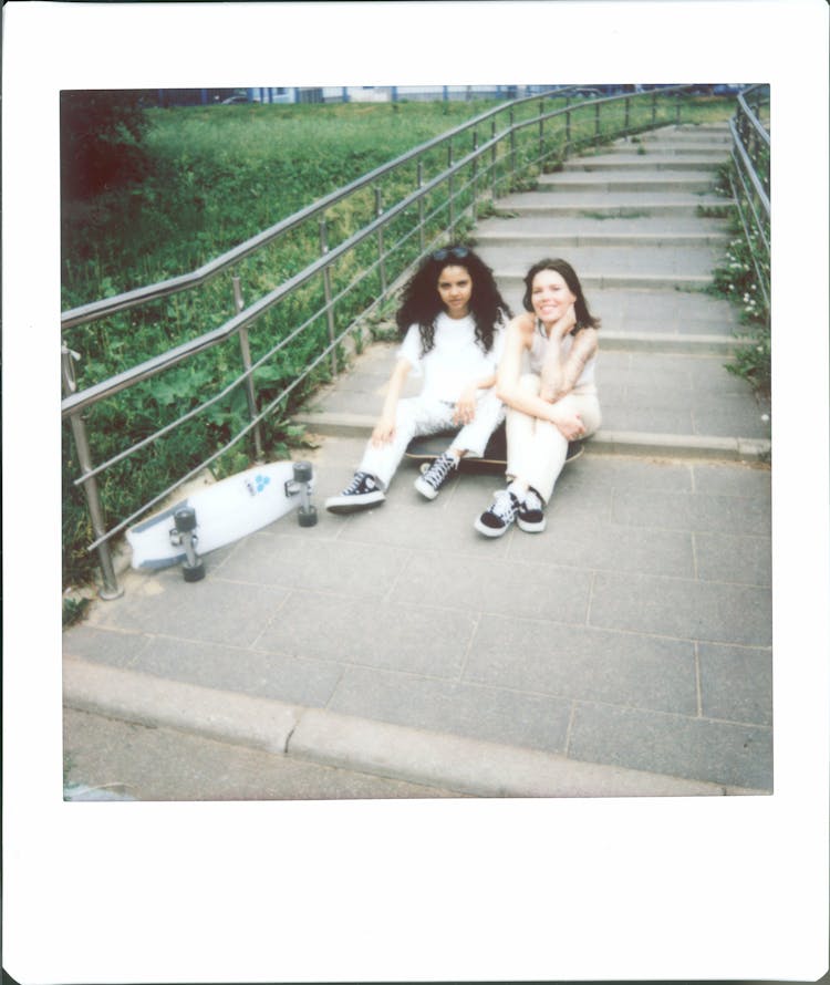 Polaroid Photo Of Women Sitting On The Floor