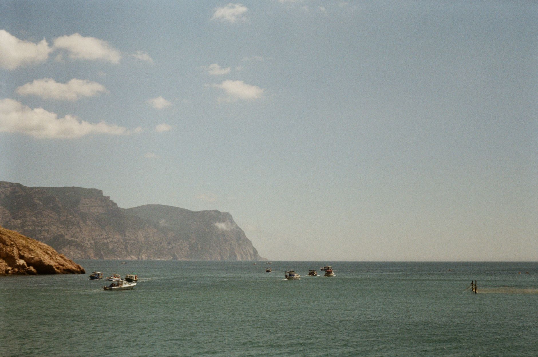 Small harbour at Latchi with fishing boats and the Akamas headland beyond