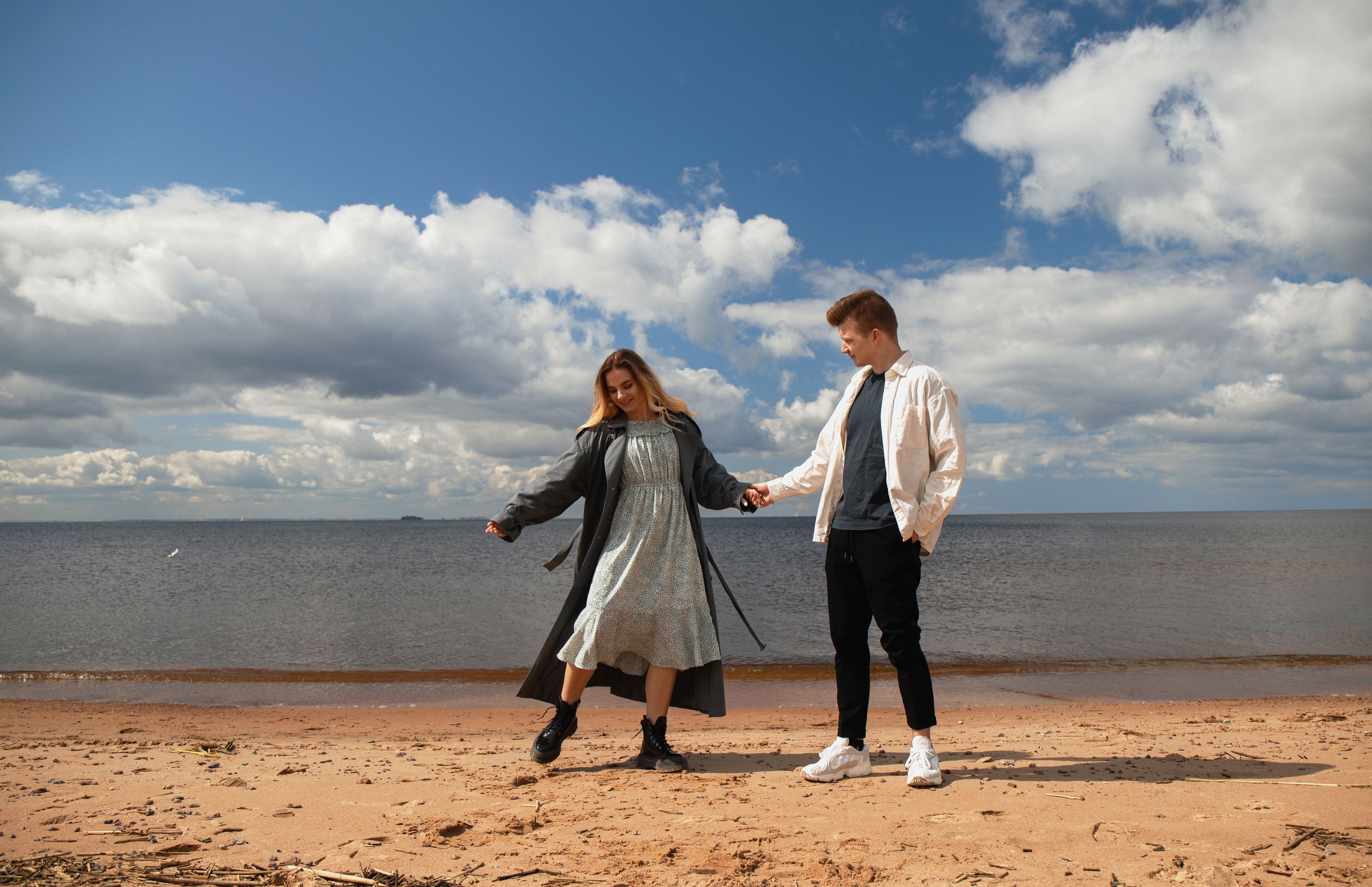 A Couple Holding Hands near the Sea · Free Stock Photo