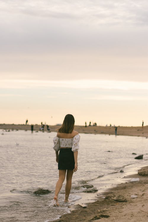 A Woman Walking on a Beach