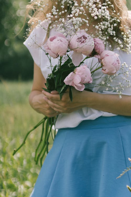 Close-Up Shot of a Person Holding Flowers