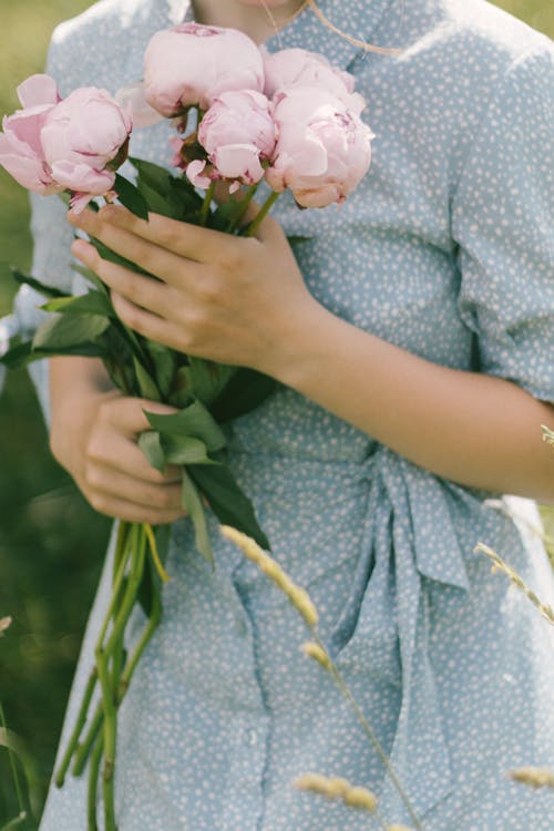 Close-Up Shot of a Person Holding Flowers