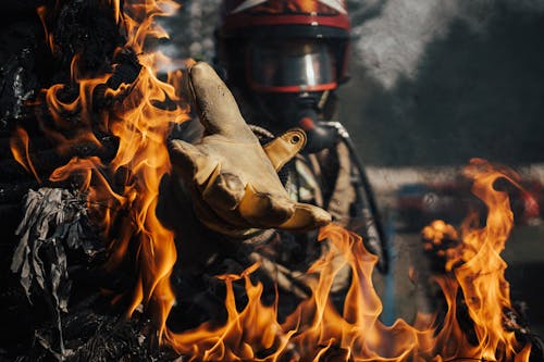 Free Firefighter Reaching in the Fire Stock Photo