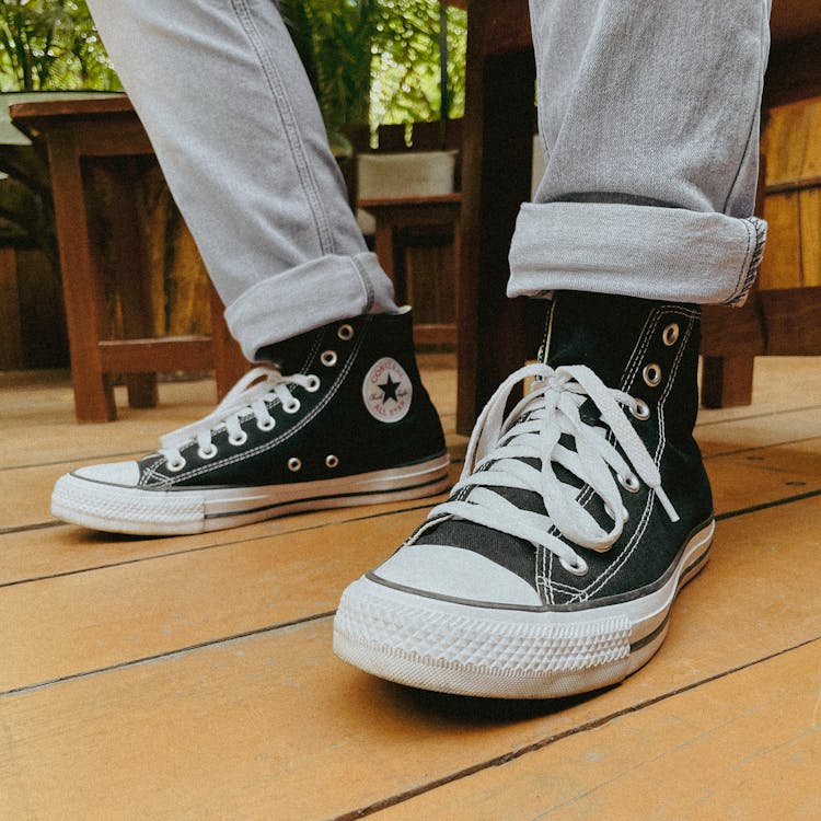 Feet In Sneakers With White Shoelaces