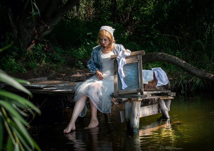 Woman Washing Clothes In A Lake