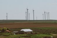 White Wind Turbines on Green Grass Field