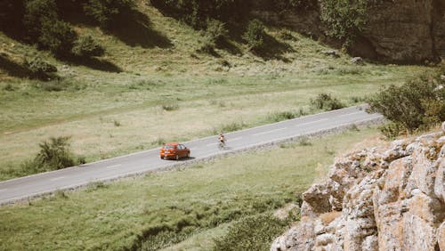 Cyclist Training on Road in Mountains