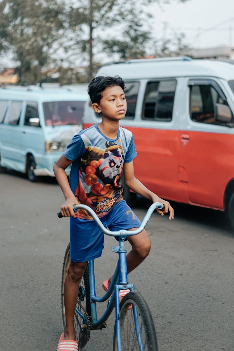 A Boy Riding A Bike