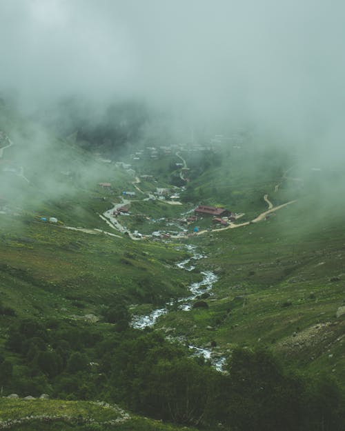 Aerial View of a Town in the Foggy Mountains