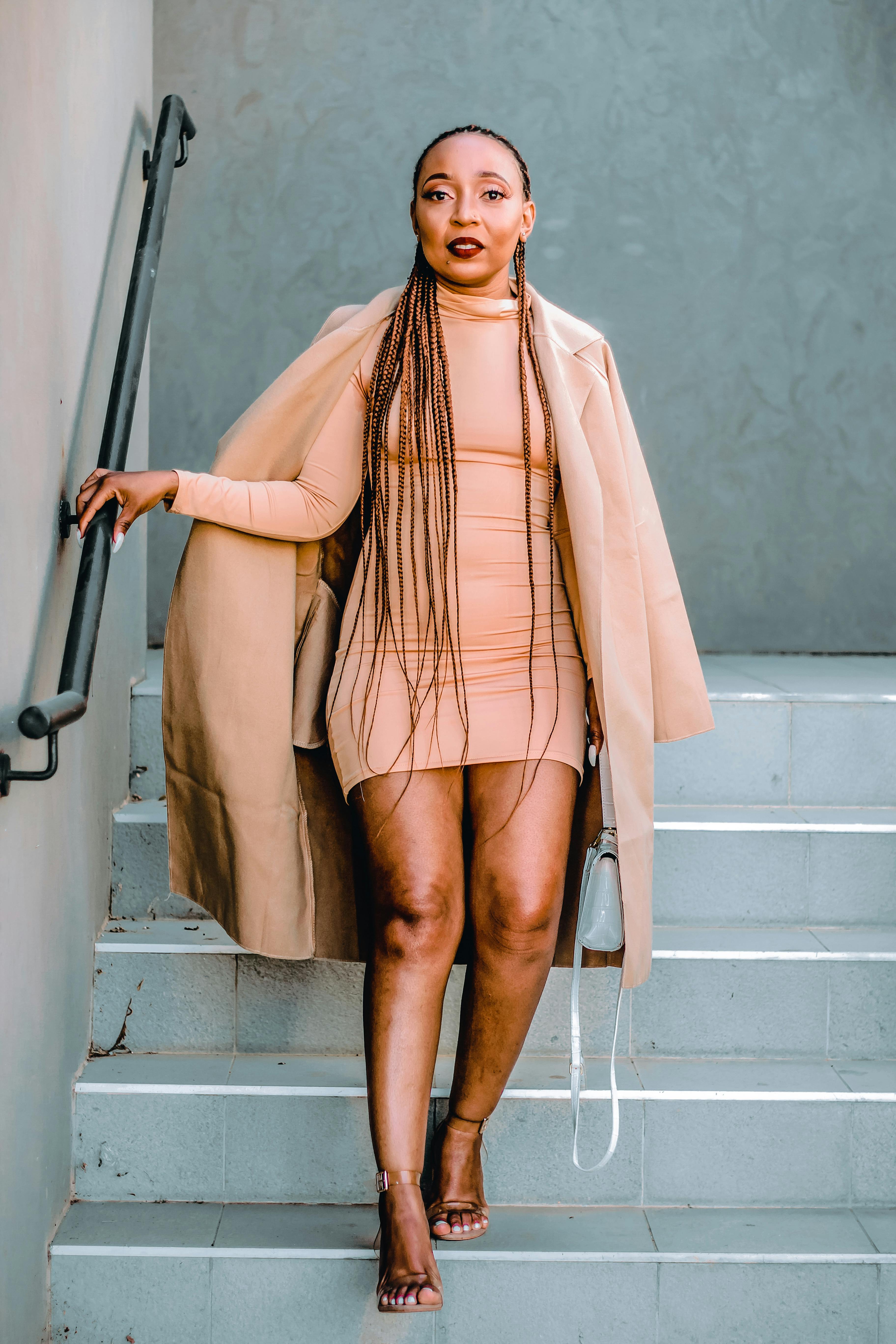 Woman in Braided Hair and Nude Clothes Going Down the Stairs · Free Stock  Photo