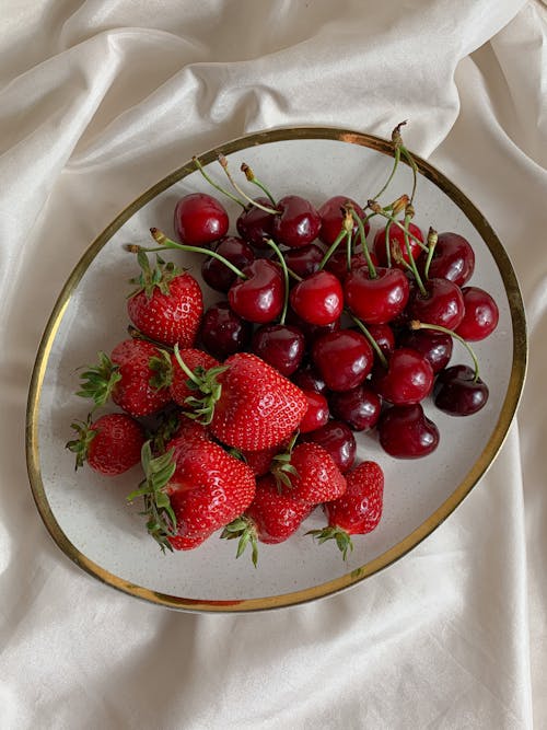 Close-Up Shot of Cherries and Strawberries on a Plate