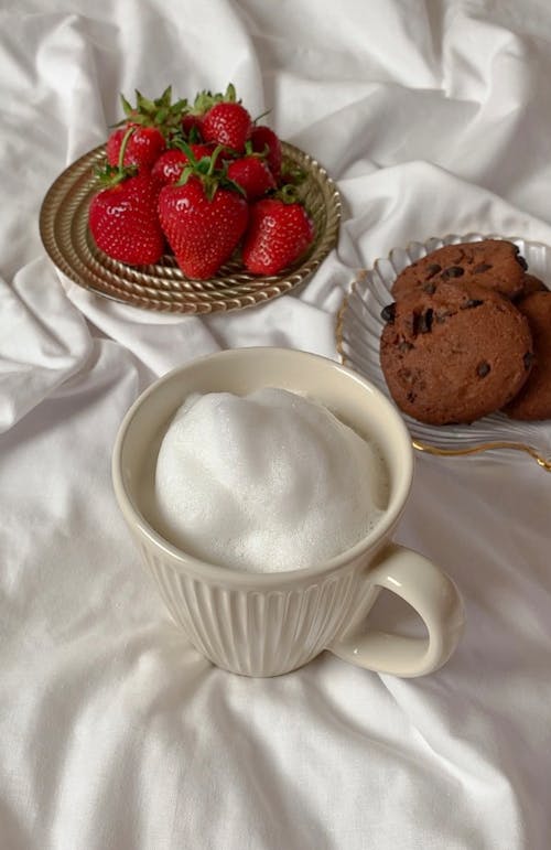 Free White Ceramic Mug Bear a Plate of Strawberries and Chocolate Chip Cookies Stock Photo