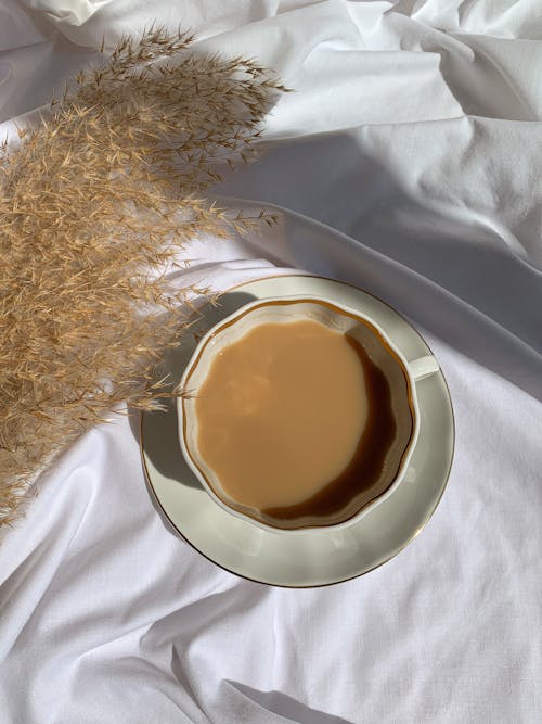 A Cup of Coffee Near Brown Dried Grass